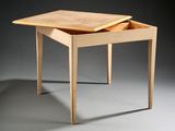 a small wooden table with a drawer on top of it
