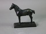 a statue of a horse that is standing on a base