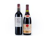 two bottles of wine sitting next to each other on a white surface