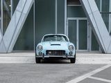 a blue car that is parked in front of a building