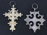 two silver and gold crosses on a black background