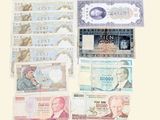 a lot of different bank notes on the table