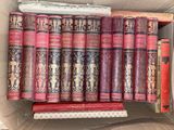 many books in a cardboard box on a shelf