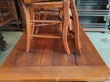 a wooden table with a wooden chair on top of it