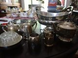 une table sur laquelle se trouvent de nombreux objets en argent