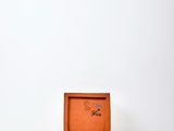 an image of a small wooden box sitting on top of a white table