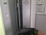 a grill that is sitting in the corner of a room