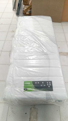 a mattress that is wrapped in plastic on the floor