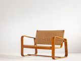 an image of a wooden chair with a woven seat on a white surface