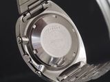 a close up of a watch on a metal bracelet