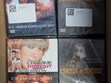 four dvds in a box on a table