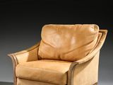 a brown leather chair sitting on top of a gray floor