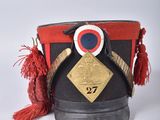 an image of a hat with a red tassel on top of it
