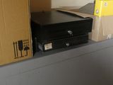 a laptop computer sitting on top of a desk next to a box