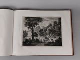 an open book with a picture of a landscape in it