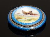 a small blue box with a picture of a bird on it