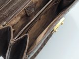the inside of a brown leather purse with multiple compartments