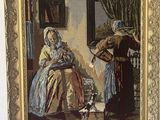 une statue représentant un homme et une femme assis devant un tableau