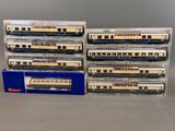 several model trains are stacked on top of each other on a table