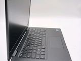 a laptop with a black keyboard on a white surface