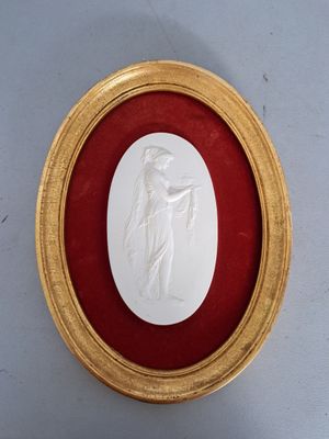 gold framed picture of a woman holding a baby in a red frame