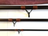 three different types of fishing rods lined up on a white surface