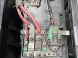 an image of a car ' s battery box with a bunch of wires in it