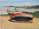two boats that are sitting on the sand