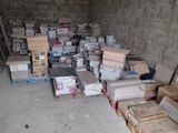 many boxes of books stacked on the floor in a room