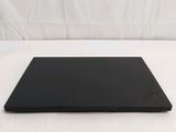 a black laptop sitting on a white surface