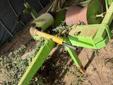 a green machine that is sitting in the dirt