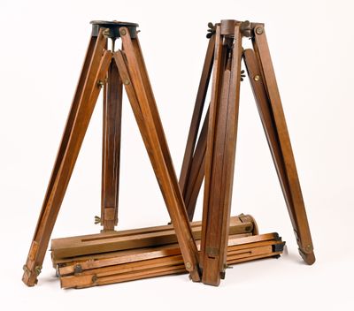 an image of a pair of wooden tripod stands against a white background
