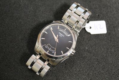 a watch that is sitting on a table with a price tag