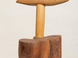 a small wooden table with a wooden top on a white pedestal