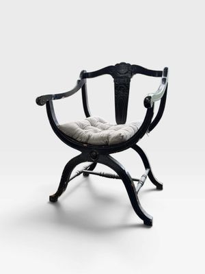 a black chair with a white cushion on top of it