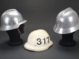 two helmets are sitting next to each other on a black surface