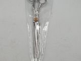 a pair of scissors in a plastic bag on a table
