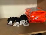 many bags of clothing on a shelf in a store