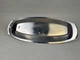 an image of a metal tray with a handle on a table