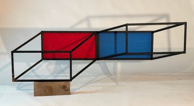 a red and blue object sitting on a wooden stand