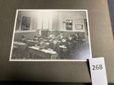 an old black and white photo of a classroom full of students