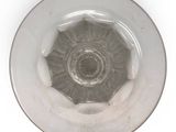 a glass bowl with a silver rim on a white surface