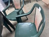many chairs and tables that are in a warehouse