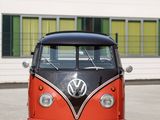 a red and black vw bus parked in front of a building