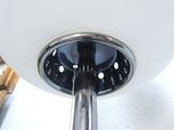 a close up view of a chrome and glass table lamp