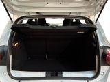 the back of a white car with its trunk open showing the rear seats