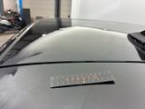 a sticker on the hood of a car in a garage