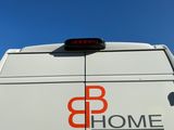 a white van with a red b home logo on the side