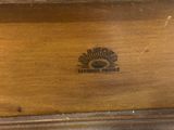 a close up of a wooden box with a logo on it