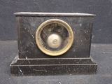 a small clock that is sitting on top of a table